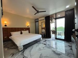 a bedroom with a bed with a marble floor at PARK CITY HOTEL & Resort in Gangāyapalle