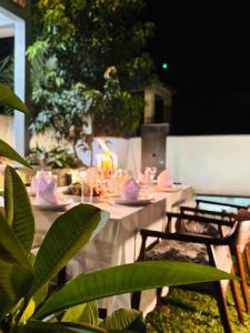 a table with candles on top of it with chairs at Villa Sathkara in Tangalle