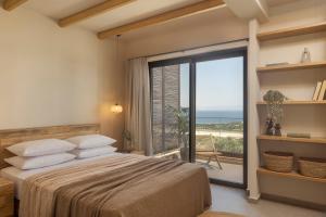 a bedroom with a bed with a view of the ocean at Don Gerassimo in Argostoli +58 photos
