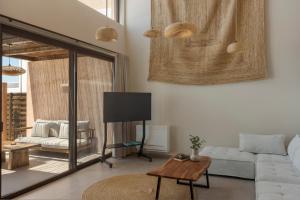 a living room with a couch and a tv at Don Gerassimo in Argostoli