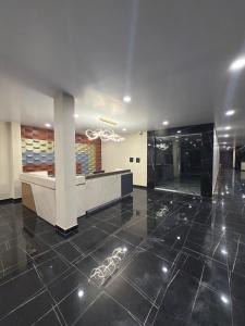 a lobby with a reception desk and a tile floor at PARK CITY HOTEL & Resort in Gangāyapalle
