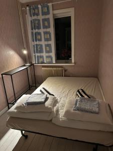 a bed with two pillows on it in a room at Nordic Villa Undrom in Undrom