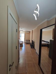 a hallway with a living room with a mirror at Dorbi Recidense in Itʼkhvisi