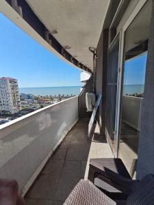 a balcony with chairs and a view of the ocean at Dorbi Recidense in Itʼkhvisi