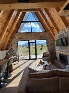 a living room with a couch and a fireplace at V Chalet in Žabljak