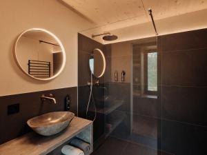a bathroom with a sink and a shower at Anima-Suites adults only in Terlano