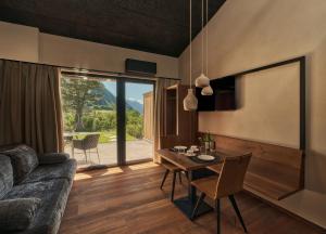 a living room with a table and a couch at Anima-Suites adults only in Terlano