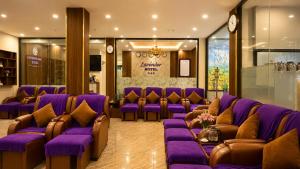 a waiting room with purple couches and purple chairs at Lavender SaPa Hotell & Spa - Free foot soak service in Sapa +62 photos