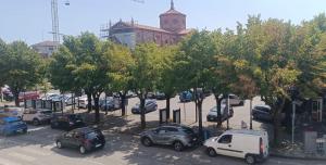 a group of cars parked in a parking lot with trees at Suite IN PIAZZA in Poggio Renatico +2 photos