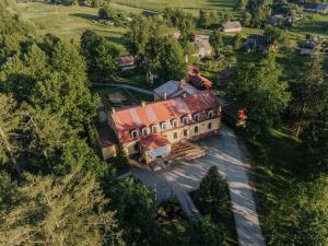 an overhead view of a large house with a red roof at Spāres muiža in Spāres Muiža
