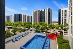 an overhead view of the pool at a hotel with buildings at Sahab - Hermes Leather Home in Sharjah