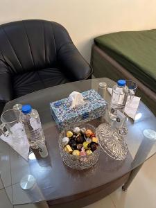a glass table with a tray of food on it at Fabulous Room in Muşaffaḩ