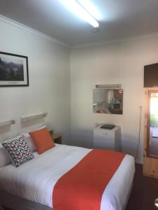 A bed or beds in a room at Sturt Motel