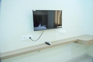a mirror on a wall with a television on it at Hotel B R Residency in Bikaner