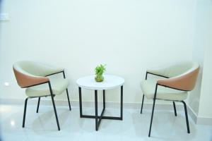 two chairs and a table in a room at Hotel B R Residency in Bikaner