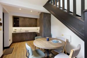 a kitchen and dining room with a table and chairs at Wings Annexe in Beaconsfield