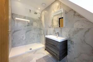 a bathroom with a sink and a shower at Wings Annexe in Beaconsfield