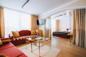a living room with a couch and a table at Hotel Bergwelt in Obergurgl