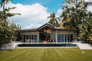an exterior view of a house with a swimming pool at Kalinaw Resort in General Luna