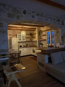 a kitchen and living room with a stone fireplace at Villa Ulu Piqeras in Piqeras