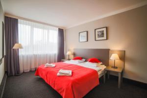 Ein Bett oder Betten in einem Zimmer der Unterkunft Hotel New Skanpol