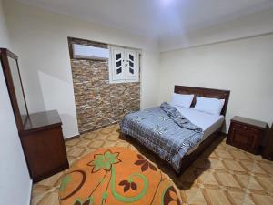 a bedroom with a bed and a brick wall at Midpoint Panoramic View - Families Only in Alexandria