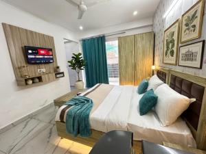a bedroom with a large bed and a tv at Hotel Akshay dream stay in Gurgaon