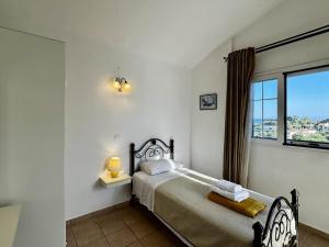 a bedroom with a bed and a window at Villa Hera in Spartià +33 photos