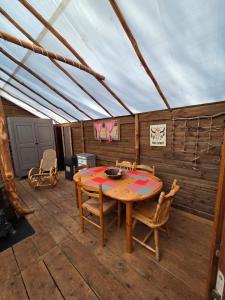 a dining room with a table and chairs in a tent at Destination Ailleurs eco-domaine & spa in Castellane