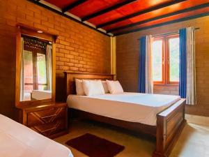 a bedroom with a bed and two windows at Senaro Villa in Sigiriya +50 photos