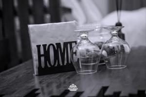 two glass vases sitting on a table next to a book at Geza Breeze Residence in Dar es Salaam