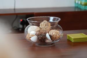 a glass vase filled with eggs on a table at Geza Breeze Residence in Dar es Salaam