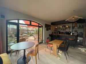a kitchen and dining room with a table and chairs at La Maison Colette - B&B in Issigeac
