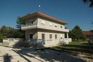 a large white house with a large balcony at Sofia Apartments in Sidari