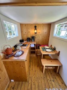 a kitchen with wooden counters and tables in a room at Schlosswirts Wohnmobilstellplatz, Schäferwagen und Bauwagen Großglockner Hochalpenstrasse in Döllach