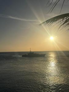 a large ship in the ocean at sunset at Lagun Paradise Curacao in Willemstad