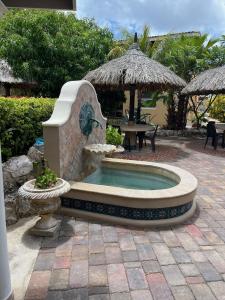 a small pool with a fountain in a patio at Lagun Paradise Curacao in Willemstad