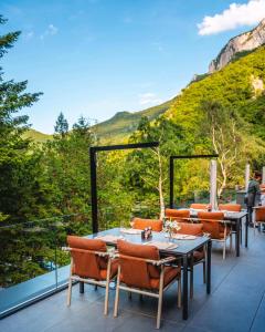 a patio with tables and chairs on a balcony at Хотел Дом на Алпиниста in Vratsa