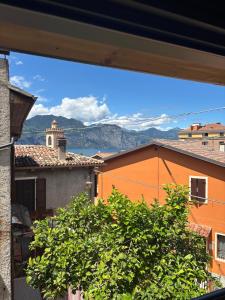 a view from a window of a city with mountains in the background at Casa Limone - a due passi dal lago in Castelletto di Brenzone
