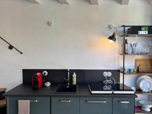 a kitchen with a sink and a counter top at Casa Limone - a due passi dal lago in Castelletto di Brenzone +6 photos