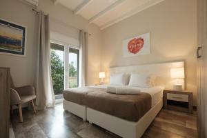a bedroom with a large bed and a window at Sofia Apartments in Sidari +116 photos