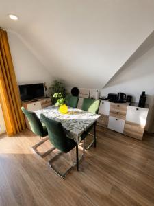 a dining room with a table and chairs in a room at Modern apartment with balcony & panoramic view in Tirschenreuth