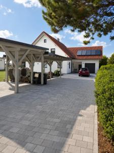 a parking lot in front of a white building at Modern apartment with balcony & panoramic view in Tirschenreuth