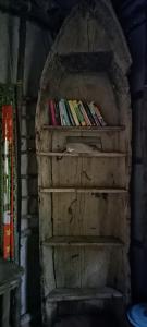 a book shelf with books on top of it at Blue Monkey Beach Cottages in Wasini