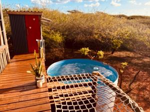 a hot tub on the deck of a house at Mudhouse Zululand in Hluhluwe