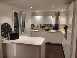 a kitchen with white cabinets and a counter top at Berner Hostel in Bern +11 photos