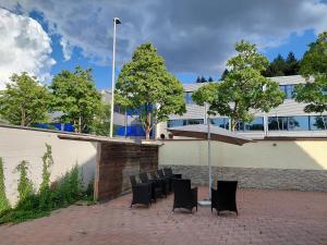 a group of chairs sitting in front of a building at Berner Hostel in Bern