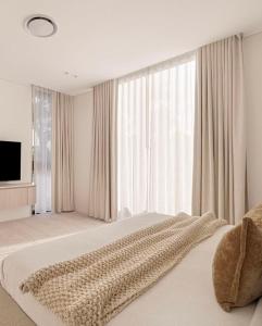 a bedroom with a large bed with a large window at Elegance Hotel - Ben Thanh Market - Central HCMC in Ho Chi Minh City
