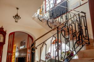 a spiral staircase in a room with a clock at Quinta Santo António in Sintra