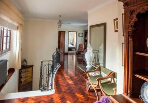 a living room with stairs and a table and chairs at Quinta Santo António in Sintra